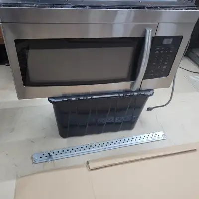 Over-the-range (built-in exhaust fan which vents to outside) Samsung microwave in stainless steel, f...