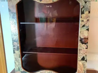 Sweet vintage three shelf wood wall cabinet with a floral design bordering the mirror. Ready to disp...