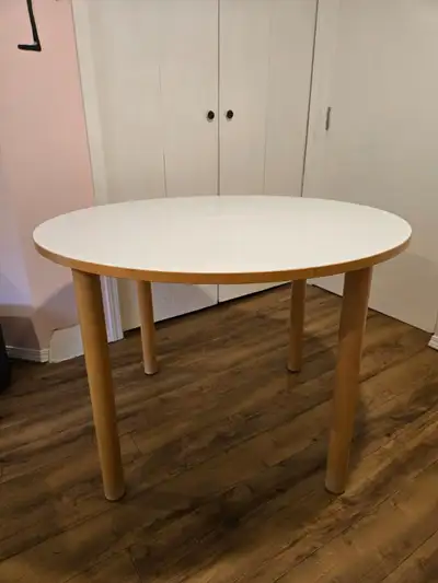 White top, solid wood legs (4); 40 inches in diameter.