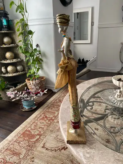 This striking African statue is perfect for adding a touch of cultural elegance to your home décor,...