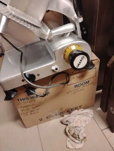 This is a used Omas meat slicer, a heavy-duty machine designed for slicing various types of meats wi...