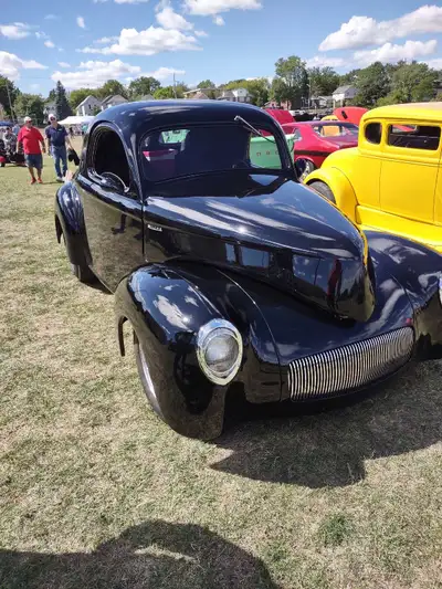 Feast your eyes on this stunning 1941 Willy's Coupe, a true classic hot rod with a sleek black exter...