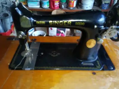 Singer Treadle Sewing Machine in the original Wooden Cabinet., View more