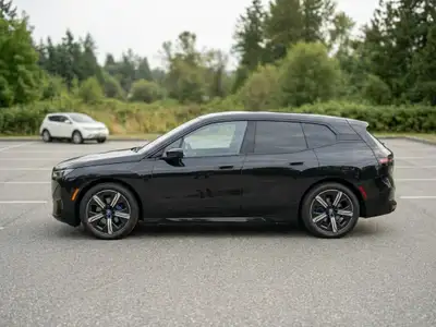Take over the lease on this stunning 2024 BMW iX xDrive40 in Sapphire Black, one of the most head-tu...