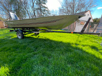 14 ft aluminum fishing boat w. 9.9 Hp Johnson. W. Trailer