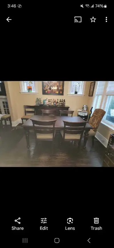 This Bombay dining room set features a beautiful dark wood table, six chairs, and a matching sideboa...