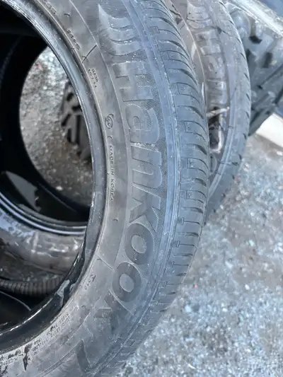 Set of two Hankook Kinergy GT tires, size 215/55R16 93H. These tires are in used condition, showing...