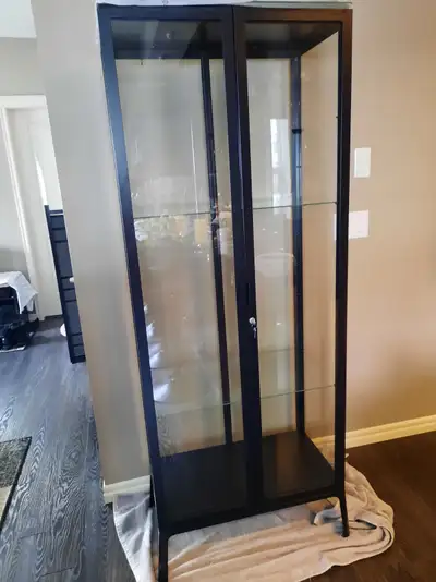 This is a four-sided glass display cabinet that could be used to display china, liquor bottles, coll...