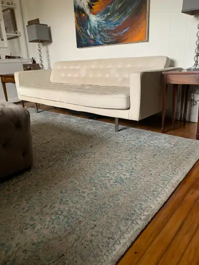 Contemporary sofa. White fabric on chrome legs. Seat and back are single cushions. Sofa needs to be...