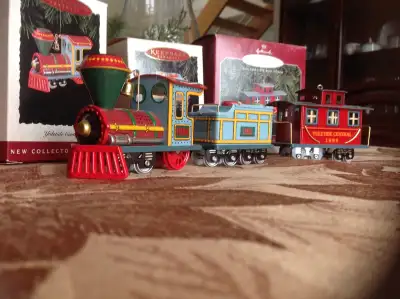 This is a set of 3 Tin Trains from the Hallmark Keepsake ornament collection, Yuletide Central Locom...