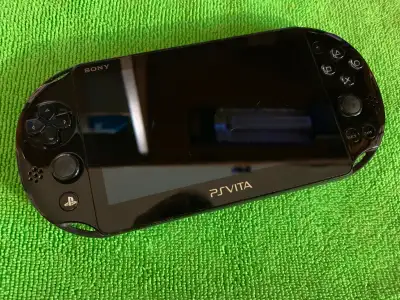 Black Playstation Vita 2000 (Slim). For parts or repair - DOES NOT WORK. Unit is complete - green li...