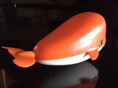 Orange and White. Wind-up function on bottom. Good bathtub toy. Swims through water and water squirt...