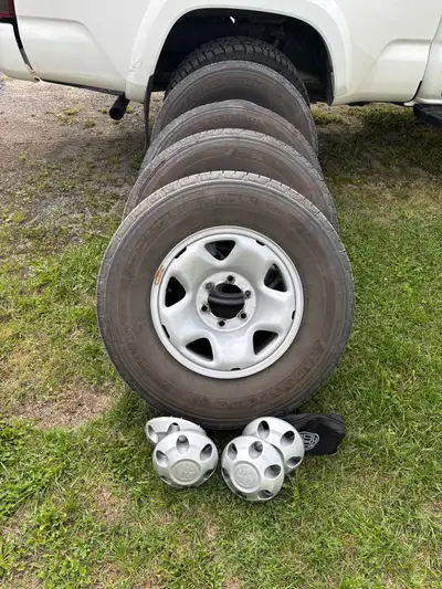 These four pre-owned Bridgestone Destination tires are sized 245/75R16 and come mounted on steel rim...