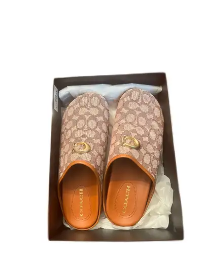 Step into comfort with these stylish Coach sandals, featuring a signature design and superior crafts...