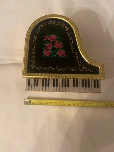 This used vintage musical jewelry box is in the shape of a piano and plays "Anniversary Song" when w...