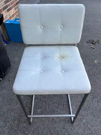 This white, cushioned bar stool is perfect for adding a touch of modern style to your kitchen or bar...