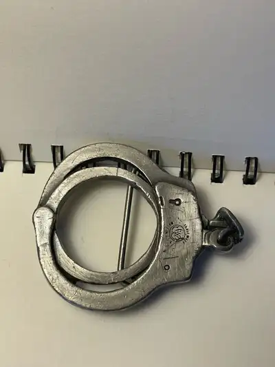 Pair of vintage belt buckles from 1981 both are solid brass and are quality pieces. Handcuffs-$45 Al...