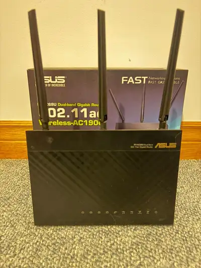 This is a used Asus AC1900 dual band gigabit Wi-Fi router, model RT-AC68U, delivering combined 1900...