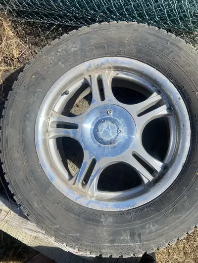 For sale set of 4 Arctictrekk 245/65R17, studded snow tires on aluminum American racing wheels 5x130...