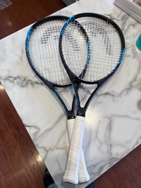 A pair of Head tennis racquet