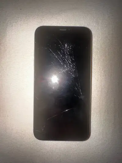 Apple iPhone 11 with a cracked screen and back It's being sold as is. Despite the cracks, the phone...