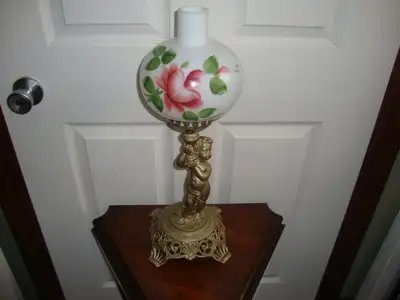1800's Victorian era candle lamp. Table lamp style with ornate cast base and hand painted glass shad...