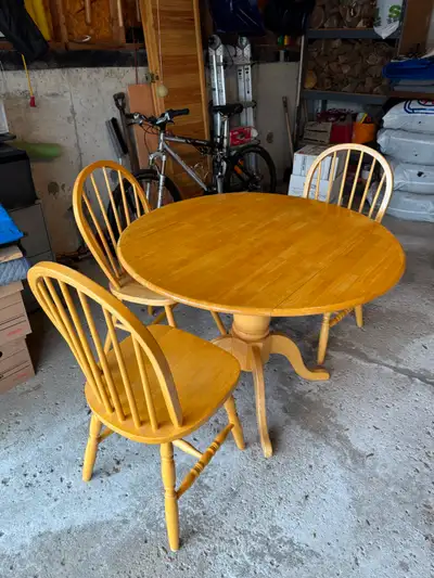 Solid maple drop leaf table with 3 chairs., View more