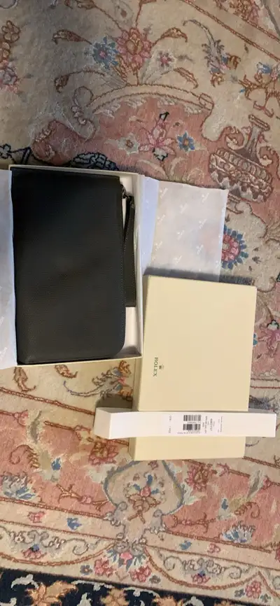 This Rolex purse is brand new and comes with its original box and packaging. It's a stylish accessor...