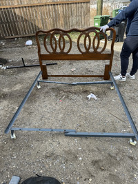 For sale is a used bed frame that combines a classic wooden head