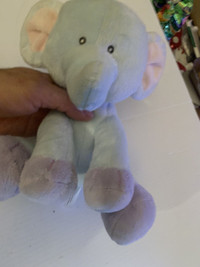 light blue stuff elephant with pink ears musical