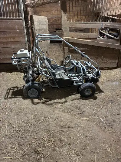 Small dune buggy with a Chinese engine( I can’t find any markings so I’m not sure of the brand or si...
