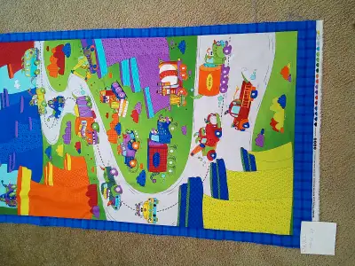 Quilt panel features "monster trucks" in overall style. Fresh cotton with bright colors of red, oran...