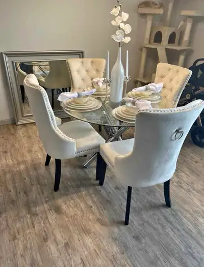 Elevate your dining space with this modern 5-piece dining set, featuring a round glass tabletop and...