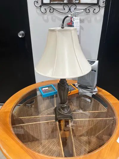 This is a used table lamp with a neutral-toned shade and a decorative base, perfect for adding a tou...