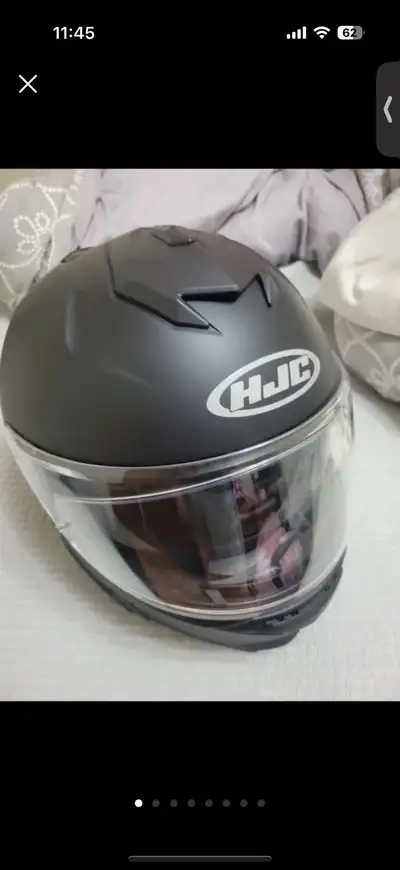 This HJC i71 motorcycle helmet is in perfect, never-used condition, featuring a sleek matte black fi...