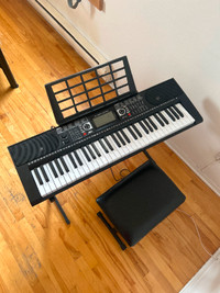 Piano keyboard with bench and pedal