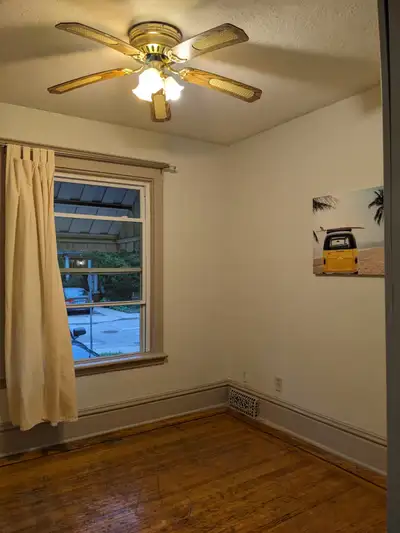 This spacious and well-lit apartment offers a comfortable living space with classic hardwood floorin...