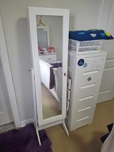 Keep your accessories perfectly organized with this white floor-standing mirrored jewelry armoire. T...