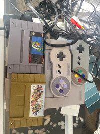 Nintendo snes with 2 games and 2 controllers, all wires