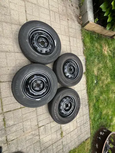 14” Tires on rims Only used 1 year 185/70/R14 Comes with covers and hub caps