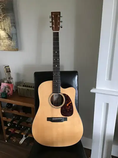 The dreadnought-size Martin DC-16DGTE Acoustic-Electric Guitar boasts a Venetian cutaway with a sati...