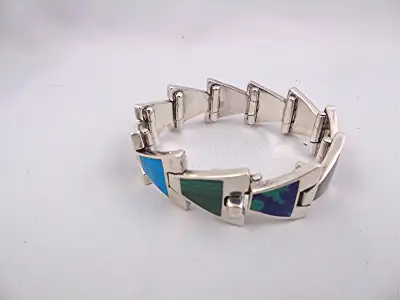 Native Navajo sterling silver bracelet with various inlayed stones, perfect condition. The bracelet...