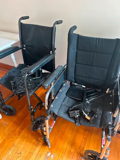 Two wheelchairs. In good working order, with foot rests