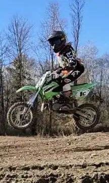 The Kawasaki KX65 is a high-performance, used motocross bike perfect for young riders, featuring a r...