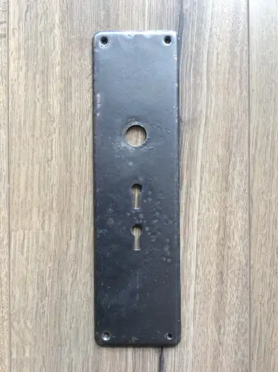 Here is an antique entrance door plate known as an escutcheon plate. Most likely brass but I don't k...